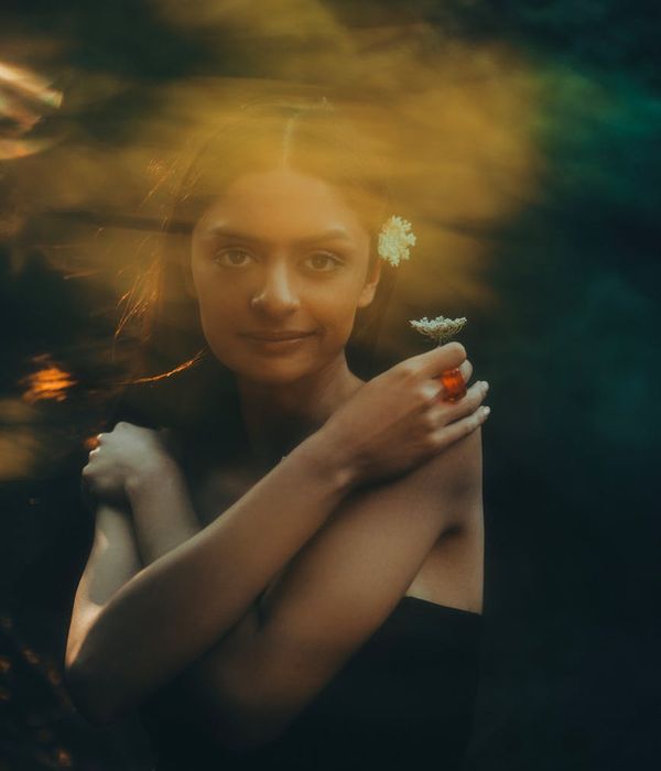 Woman with a serene expression, bathed in soft golden light, suggesting mental clarity.